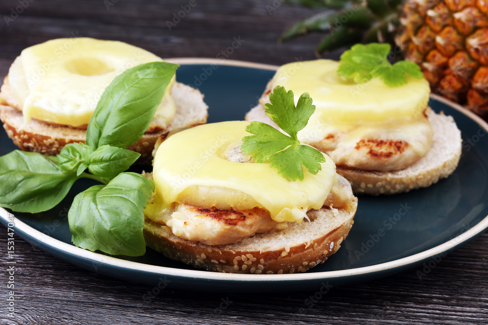 toast hawaii, , cheese and pineapple on wooden background with chicken breast toast hawaii, , cheese and pineapple on wooden background with chicken breast