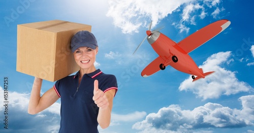 Delivery woman with parcel gesturing thumb up 