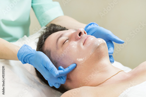 Man in the mask cosmetic procedure in spa salon 