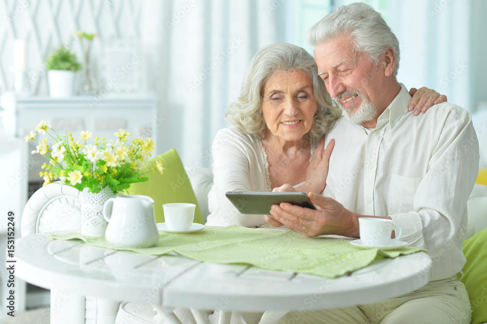 Happy elderly couple using a tablet computer Happy elderly couple using a tablet computer
