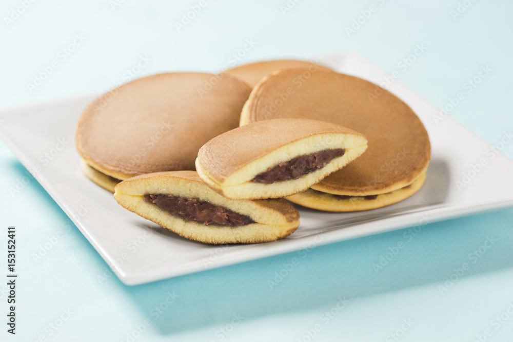 Dorayaki, Japanese Sweet Bean Pancakes, on Blue Background Dorayaki, Japanese Sweet Bean Pancakes, on Blue Background