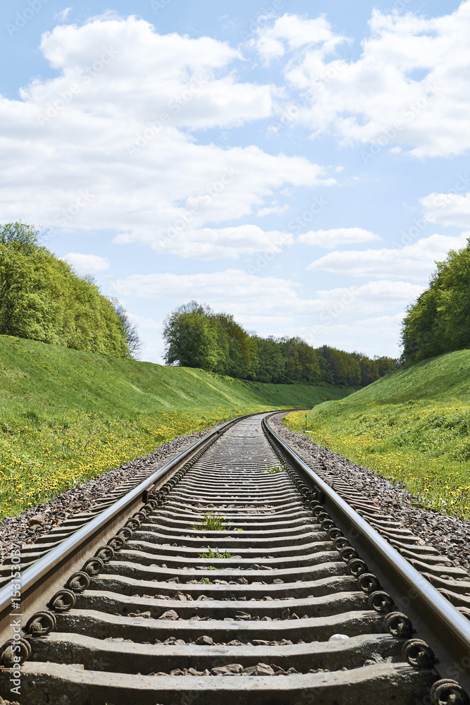 Fototapeta premium Railroad track curve around a bend in rural 