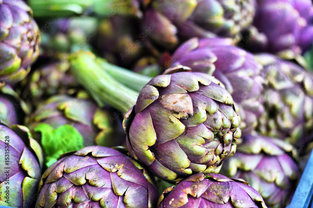 Fototapeta premium Pile of Artichoke on display at a farmers market