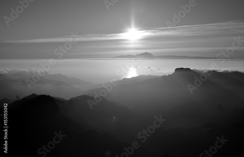 Sunset from the mountains, summit of Gran canaria and Tenerife island in the distance, Canary islands, monochrome mode photo