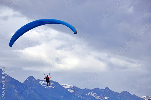 Tandem parachute jump in the background of sky © Volodymyr