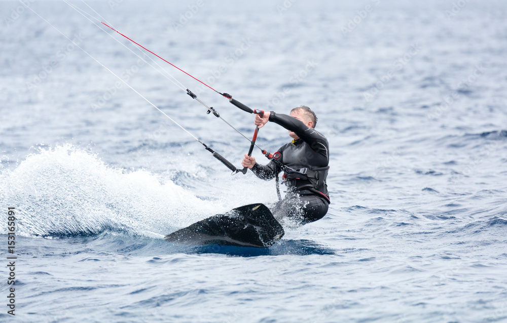 Naklejka premium A kite surfer try to ride the waves