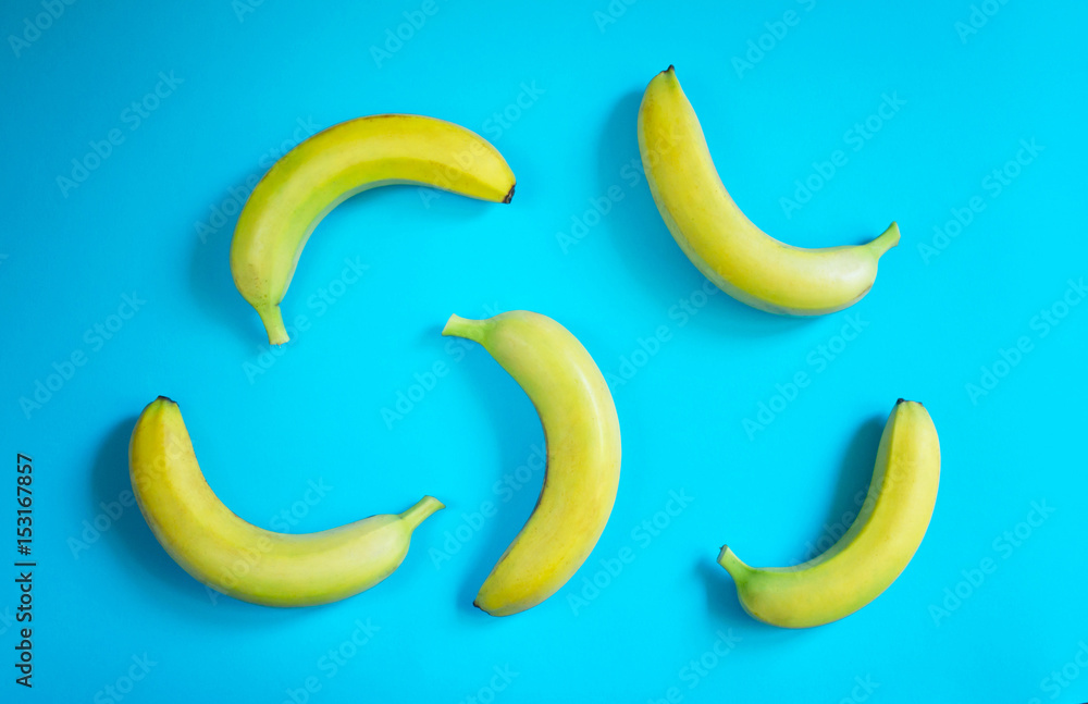 Yellow bananas on blue background