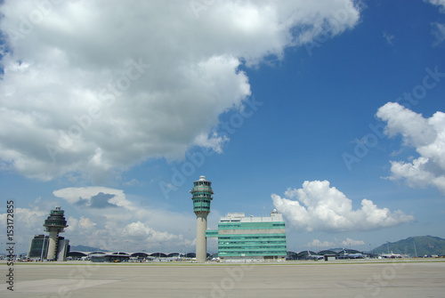 Airport traffic control tower at Hong Kong International Airport on a clear sunny day