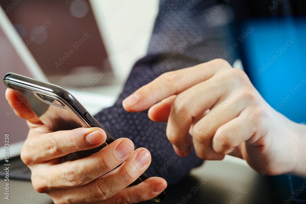 close up of businessman hand working with mobile phone and laptop and digital tablet computer in modern office close up of businessman hand working with mobile phone and laptop and digital tablet computer in modern office