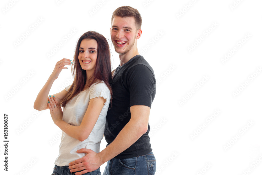 a cheerful young man embraces a beautiful smile girl a cheerful young man embraces a beautiful smile girl