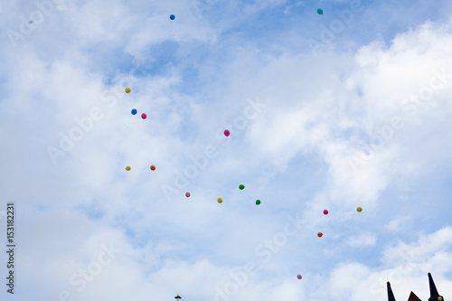 Balloons on cloudy sky