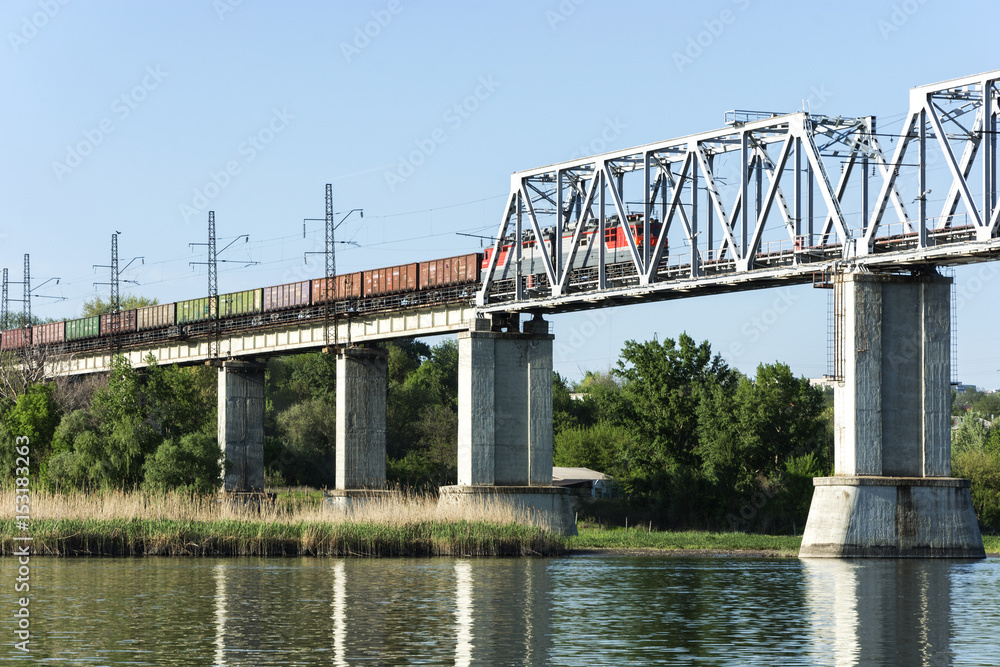 A freight train goes over the bridge across the bridge. A freight train goes over the bridge across the bridge.