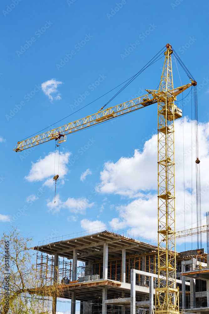 construction crane and the building against the blue sky construction crane and the building against the blue sky