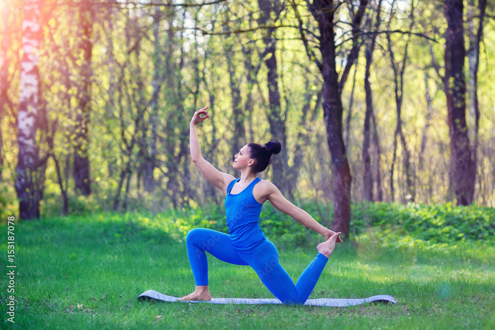 Young woman doing yoga exercises in the summer city park. Health lifestyle concept. Young woman doing yoga exercises in the summer city park. Health lifestyle concept.