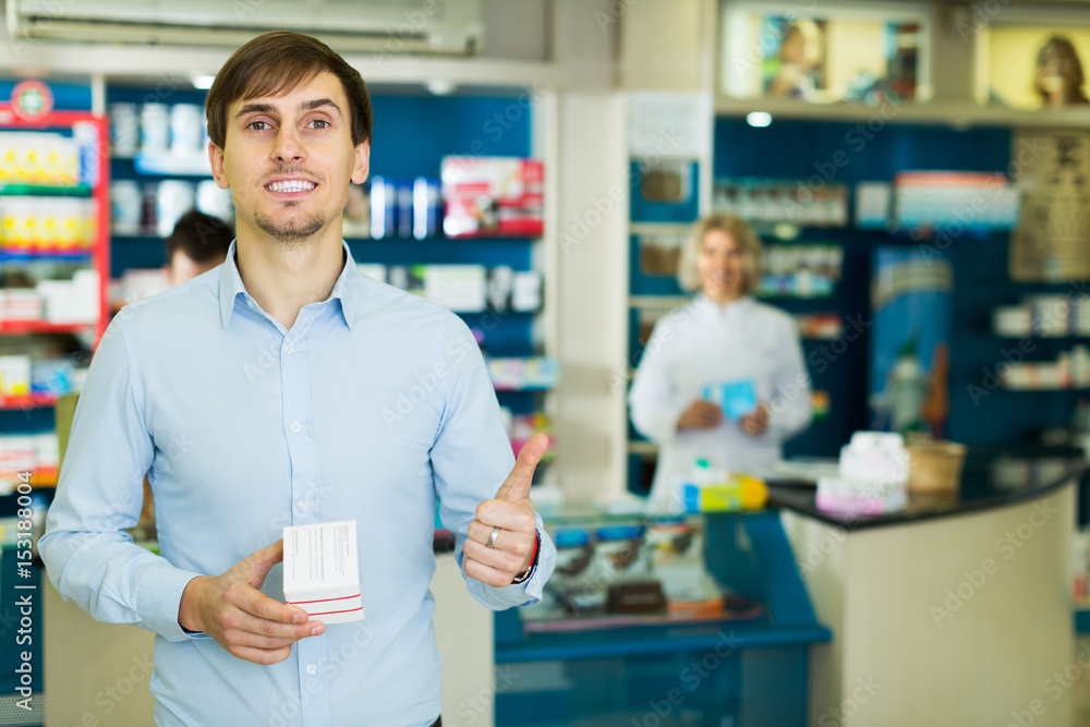 Man near counter in pharmacy