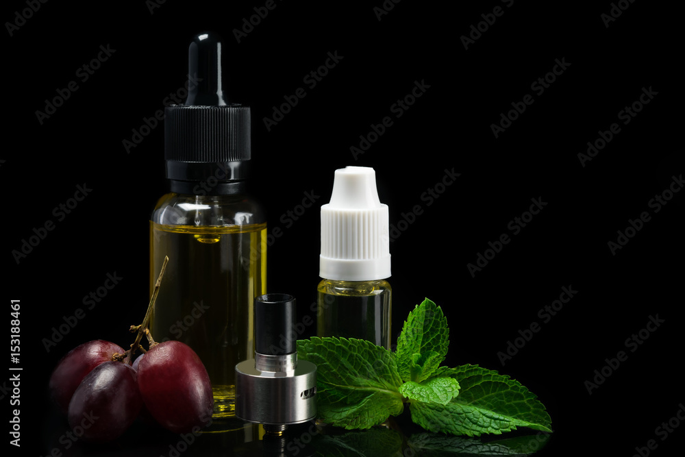 cistern from an electronic cigarette and flavors of fruit flavors, a concept on a black background cistern from an electronic cigarette and flavors of fruit flavors, a concept on a black background