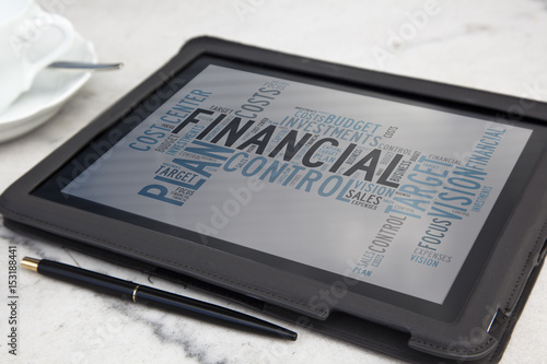 tablet with financial word cloud