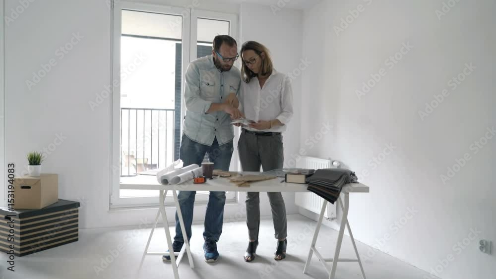 Young couple choosing colour from palette for their new home
Young couple choosing colour from palette for their new home