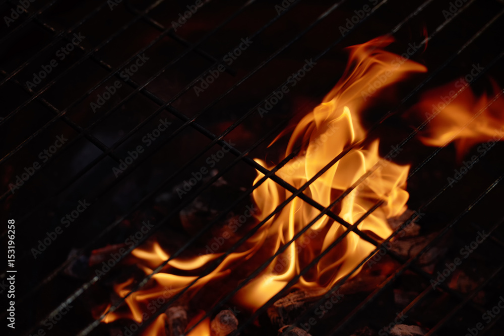 Flame of fire under barbecue grate Flame of fire under barbecue grate