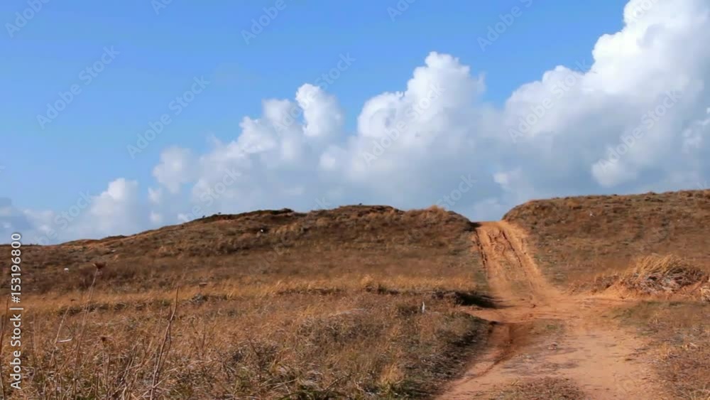 Off Road Sand Dune Motocross and Auto Sport Track on Blue Sky and Clouds in Motion Background. Time Lapse Off Road Sand Dune Motocross and Auto Sport Track on Blue Sky and Clouds in Motion Background. Time Lapse