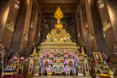 Ornate and golden altar inside the decorated Phra Ubosot or Ordination Hall, which is the holiest prayer room at the Wat Pho (Po) temple complex in Bangkok, Thailand.