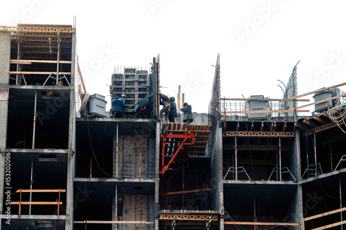 Builders are installing a site for the construction of a house. The concept of erecting a multi-storey concrete house.