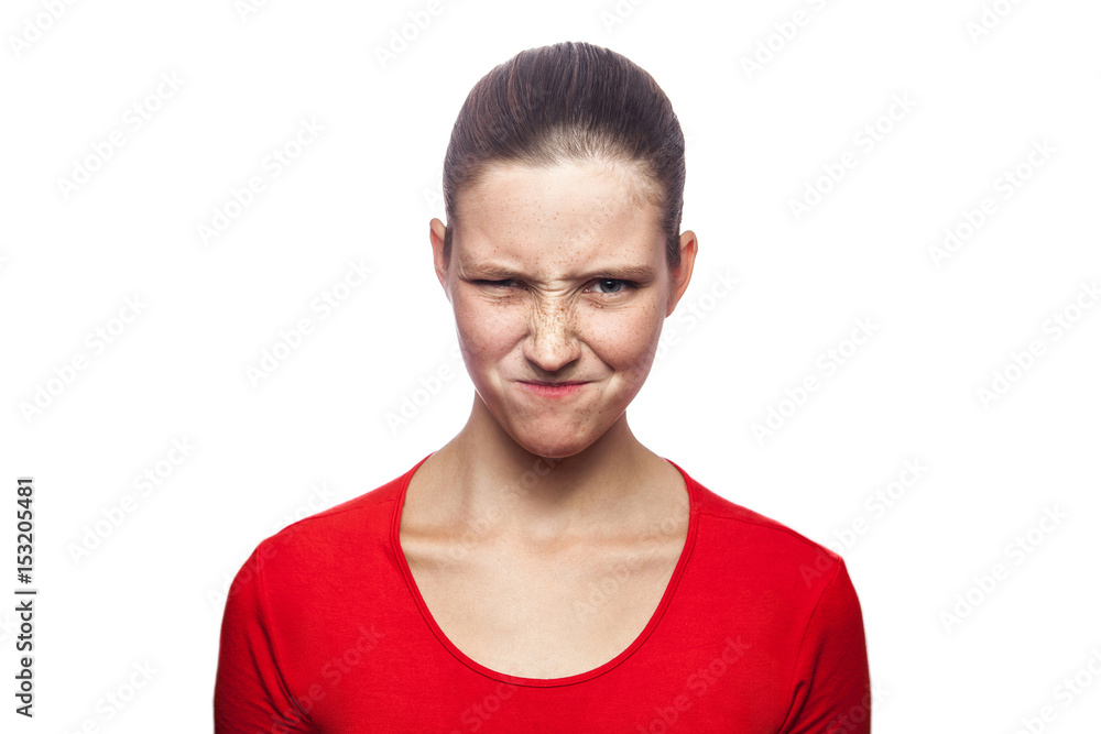 Portrait of cunning woman in red t-shirt with freckles. looking at camera, studio shot. isolated on white background. Portrait of cunning woman in red t-shirt with freckles. looking at camera, studio shot. isolated on white background.