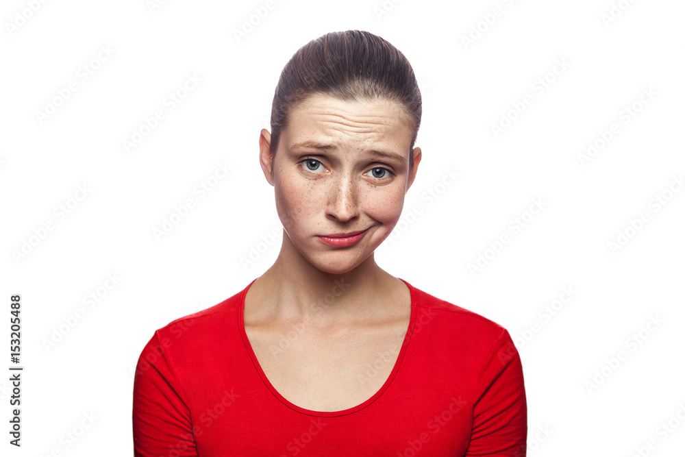 Portrait of sad unhappy woman in red t-shirt with freckles. studio shot. isolated on white background. . Portrait of sad unhappy woman in red t-shirt with freckles. studio shot. isolated on white background. .