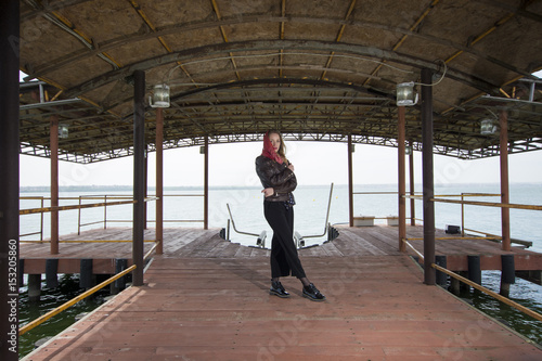 Young girl posing on pier at Lake Siutghiol 
