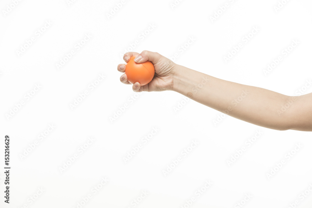 The hand holds an orange round object The hand holds an orange round object