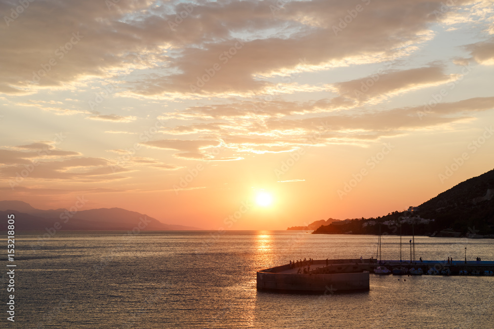 Sunset over the sea. Pier on the foreground, Loutraki, Greece