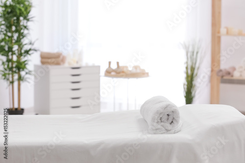 Foto Towel on massage table in modern spa salon