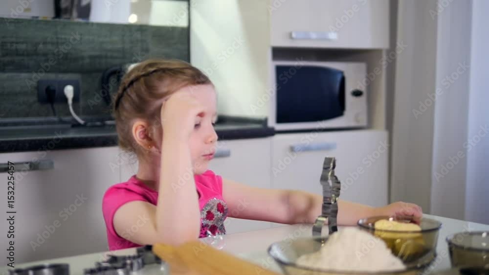The portrait of the little girl playing with the cooking form. Timelapse. HD. The portrait of the little girl playing with the cooking form. Timelapse. HD.