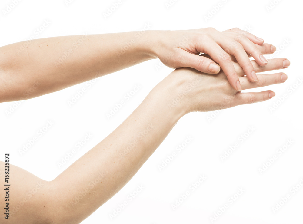 The hand gently holds and massages the other hand
