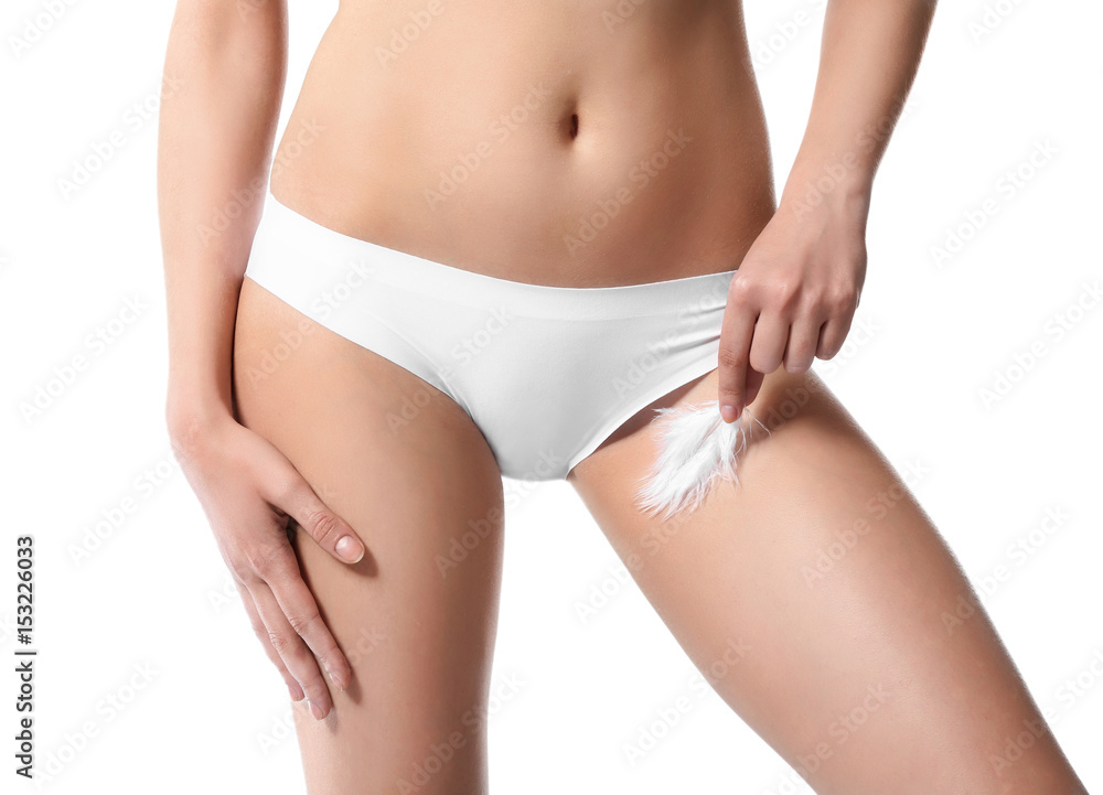 Beautiful young woman with feather on white background, closeup. Epilation concept