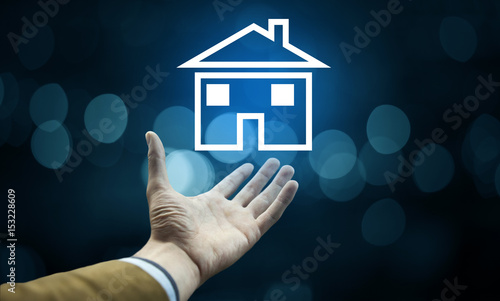 businessman hand house in screen