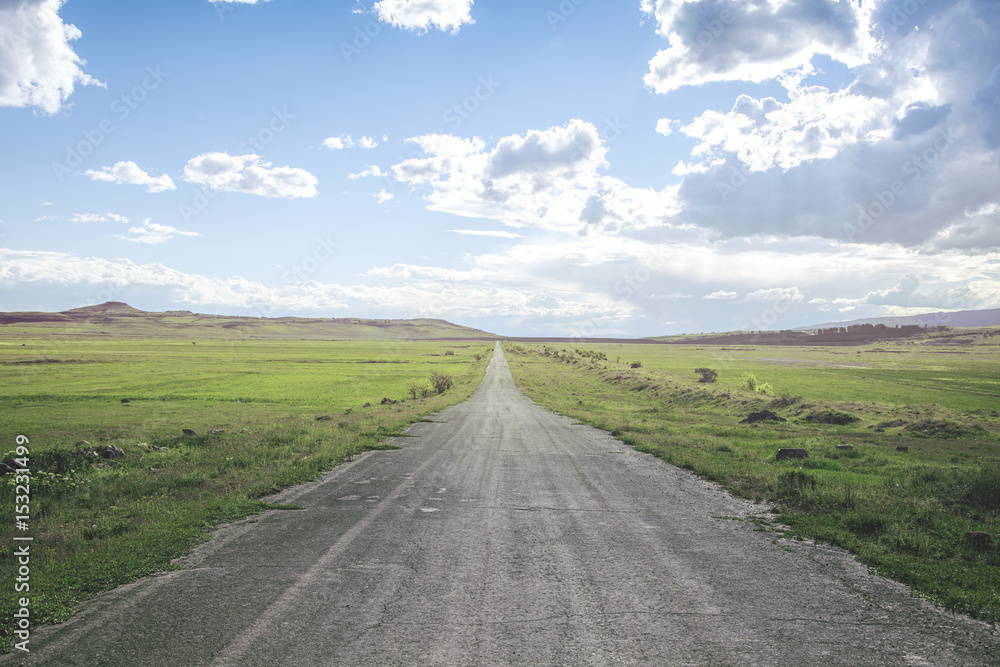 beautiful road with around green grass