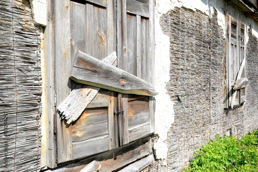 Window of an old wooden abandoned house demolishing in the wilderness