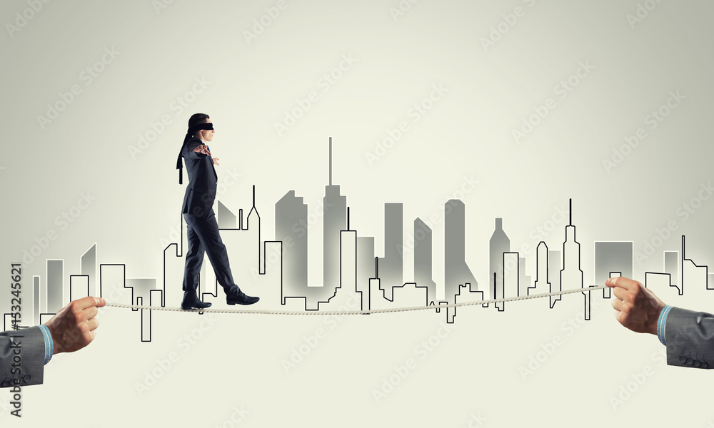 Business concept of risk support and assistance with man balancing on rope Business concept of risk support and assistance with man balancing on rope
