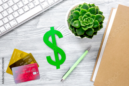 student's desk with dollar sign for fee-paying education set gray background top view mock up photo