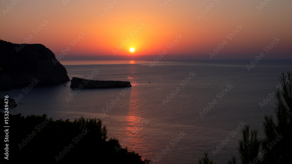 Lovely sunset over Benirras beach on a quiet summer evening, Ibiza, Balearic Islands, Mediterranean Sea, Spain.