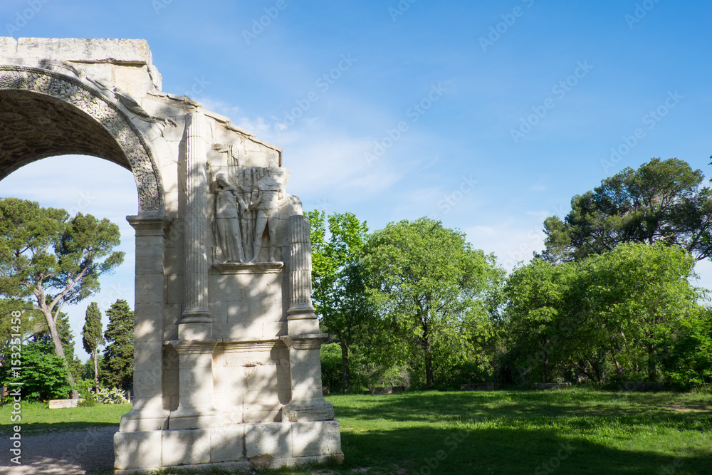 France, Saint Remy de Provence in Southern France, Glanum, The triumphal arch of Glanum (10-25 BC) 1921.Mausoleum of the Julii (about 40 BCE), in background.