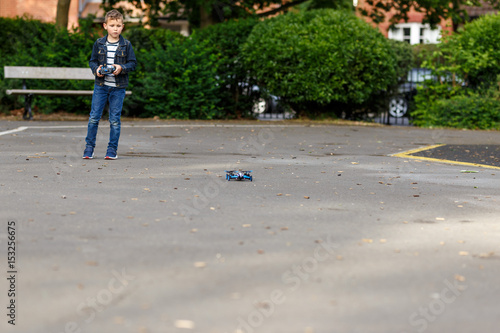 Boy plays with his drone in the park photo