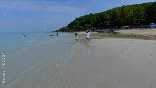 happy couple running on the beach. Happy couple running on a tropical beach in the ocean at sunset. Couple running on a sandy beach. Romantic couple running on a sandy beach photo