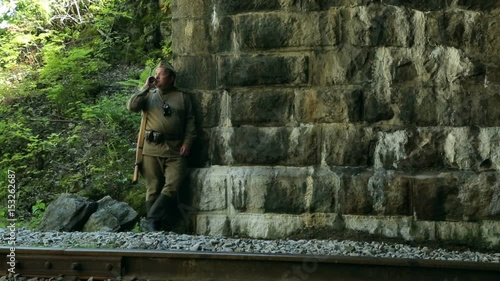 Actor dressed in military uniforms. Soldiers of the Soviet army smokes. The army of the USSR. A soldier with a rifle guarding a railway tunnel.
