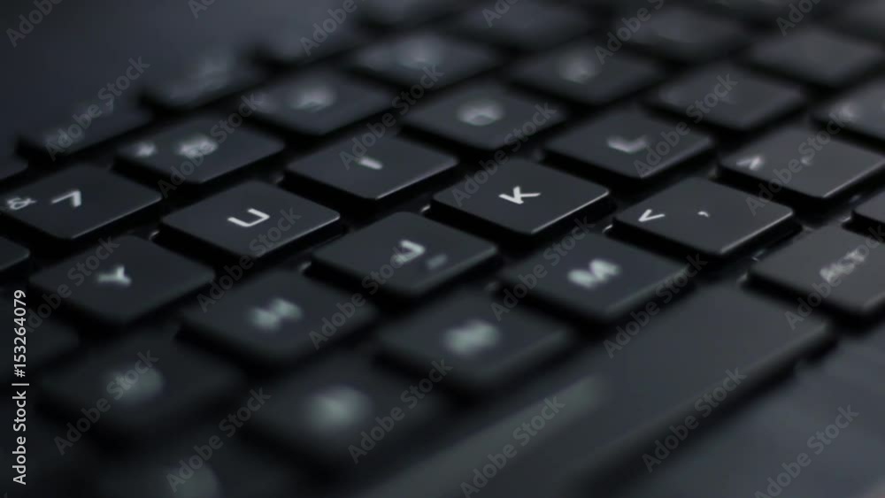 Angled close up of pulsing back lit laptop keyboard with red nahimic RGB keys flashing side to side Angled close up of pulsing back lit laptop keyboard with red nahimic RGB keys flashing side to side