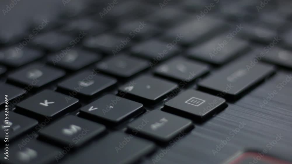 Close up move left to right over back lit laptop keyboard with red pulsing nahimic RGB keys flashing side to side Close up move left to right over back lit laptop keyboard with red pulsing nahimic RGB keys flashing side to side