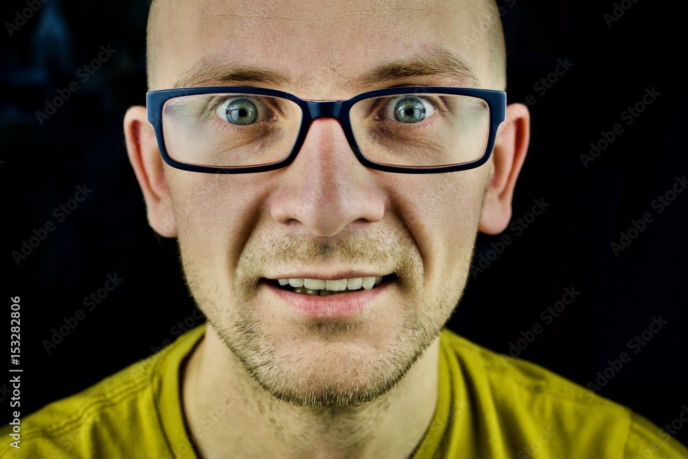 Man in yellow tshirt and blue glasses Man in yellow tshirt and blue glasses