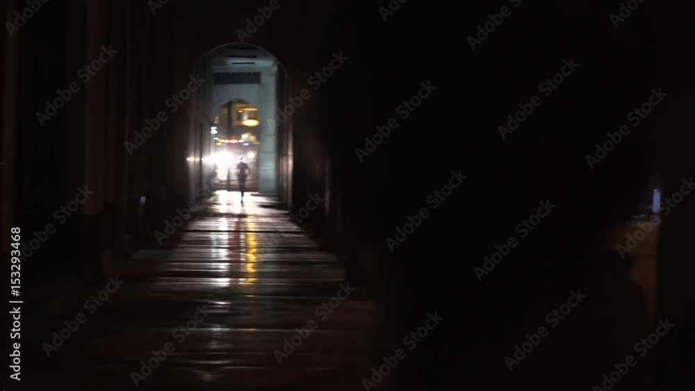 Silhouettes in dark tunnel