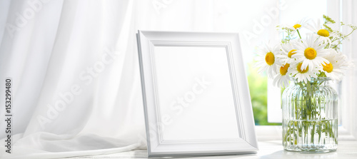  Picture frame near window with flower